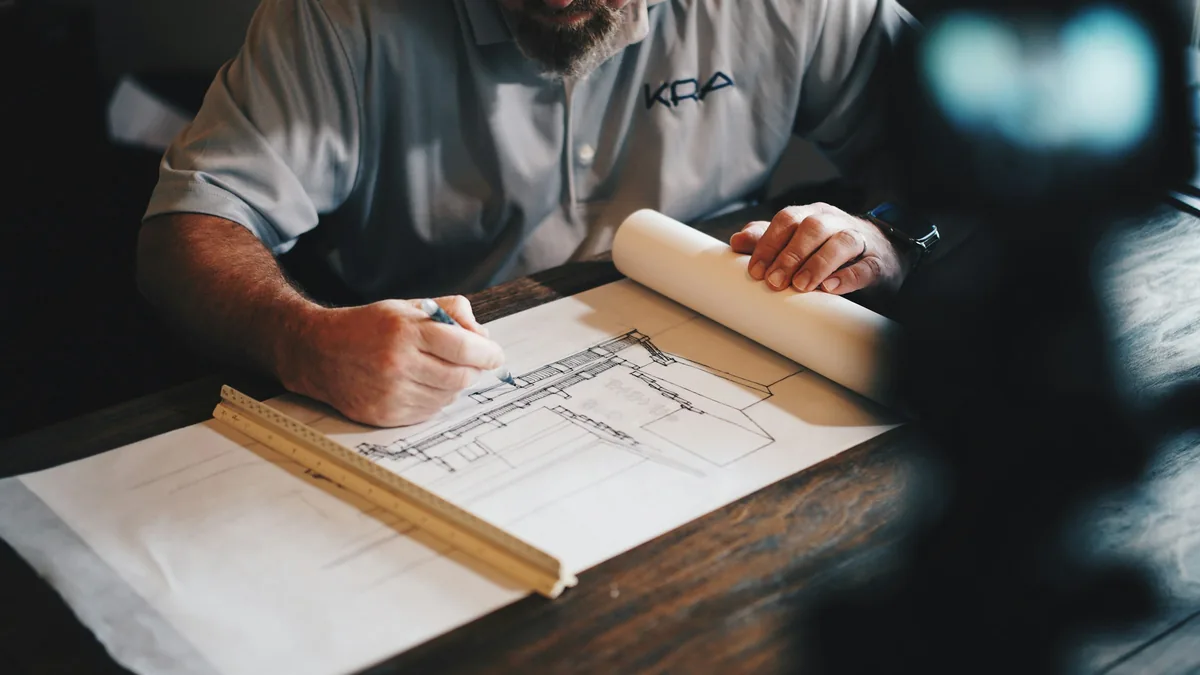Construction blueprints and planning documents spread on a work table