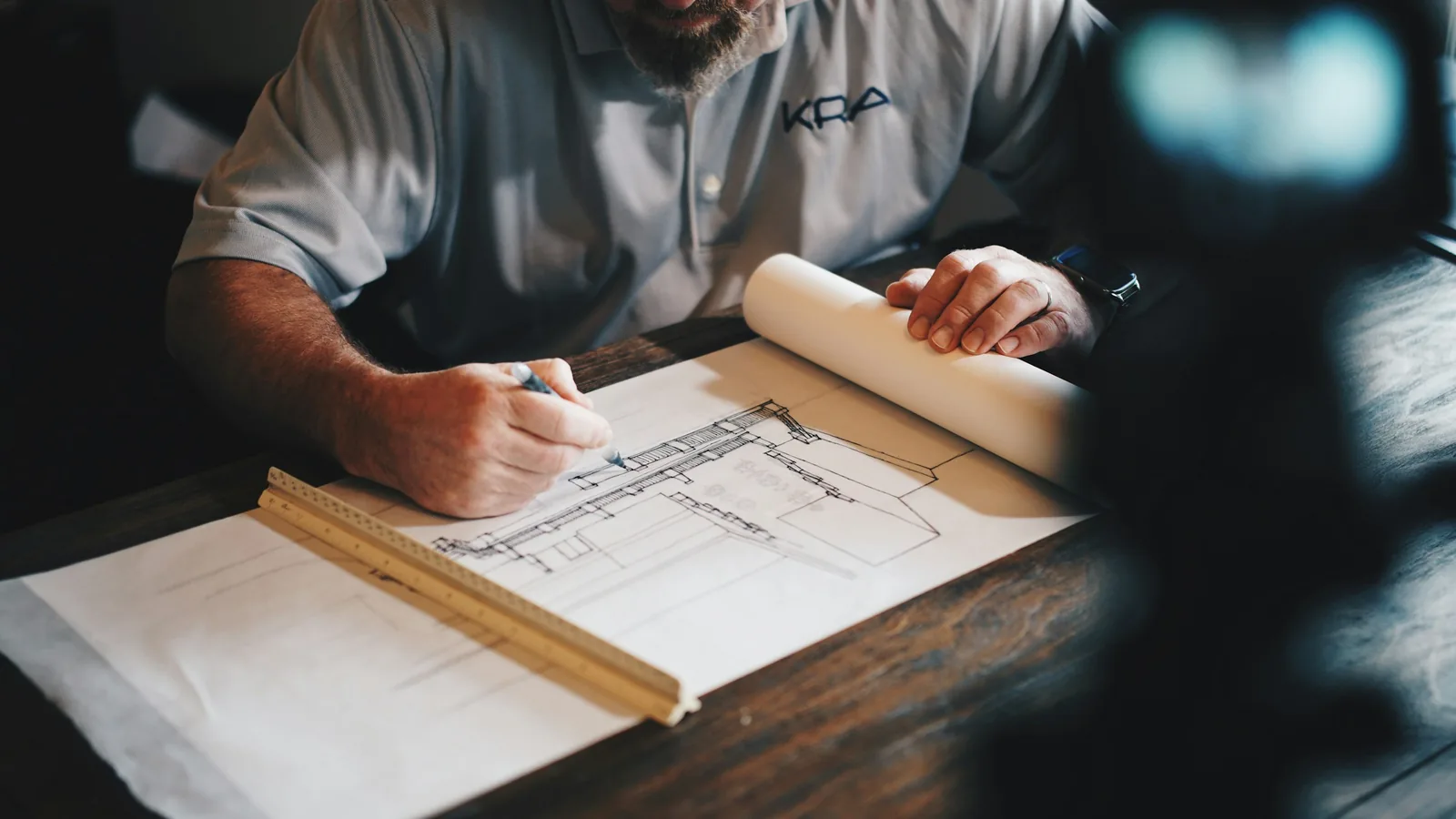 Construction blueprints and planning documents spread on a work table