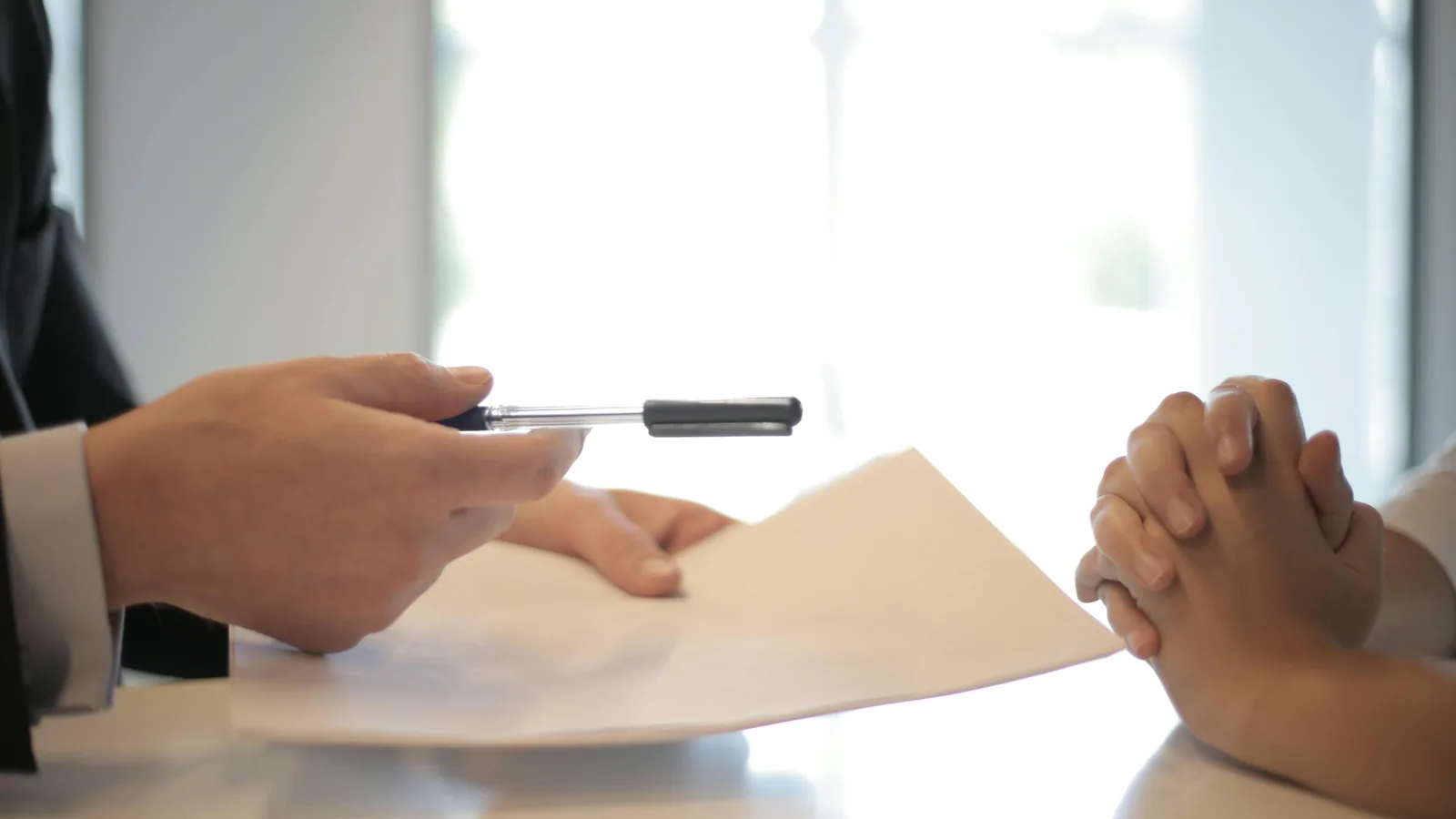 Close-up of hands reviewing and signing a home improvement contract